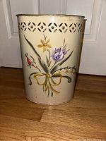 Front view showing the hand-painted floral design and pierced metal pattern around the top edge.