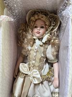 Full view of vintage Seymour Mann collectible doll in box with protective packaging.