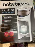 Front of product box showing branding and features of Baby Brezza Formula Pro Advanced bottle maker