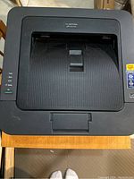 Top view of the Brother HL-2270DW printer showing paper output area and status LEDs on side panel.