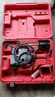 View of Milwaukee Whole Hog power tool in red carrying case with accessories