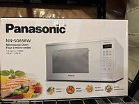 Box exterior showing Panasonic microwave model NN-SG656W, front image with product features and photo.