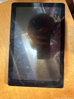 Front view of RCA tablet showing the screen with scratches and reflections.