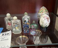Main overview photo showing 7 inside painted frosted glass bottles, 2 decorative eggs on black stands, and 2 small glass candle holders.