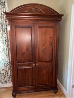 Front view of armoire showing overall design and finish