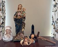 Full lot view including four figurines, a wooden cross, and a small dark blue picture easel.