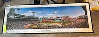 Full view of framed panoramic photograph of Fenway Park during 2004 World Series Ring Ceremony with crowd and players on field, signatures around border