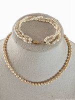 Photo showing both the bracelet and necklace displayed on a jewelry bust to illustrate size and appearance.