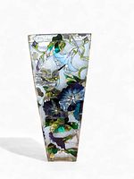 Front view of the tapered clear glass vase showing the colorful hand painted hummingbirds, blue and purple flowers, twisted green vines and leaves.