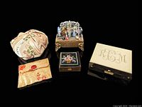 Overview of all five small trinket boxes and fabric bags for scale and condition assessment.