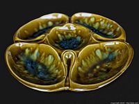 Front angled view showing divided sections and green blue drip glaze finish.