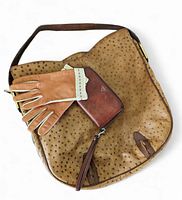 Overall view of the three items: tan textured leather shoulder bag, light brown leather and crochet driving gloves, and brown Fossil leather wallet.