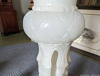 Close-up of the carved patterned base of the alabaster plant stand.