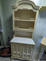 Full view of the French style cabinet with hutch showing the painted floral decoration, shelves, and cabinet doors.