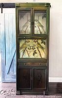 Full view of the large bar cabinet showing upper doors and bird decoupage artwork on the drop-down panel.