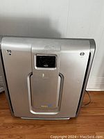 Front view of Rabbit Air purifier unit showing central black filter panel and control buttons.