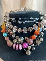 Full view of assorted 70-80's choker necklaces on display stand.