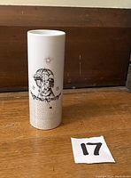 Front view of vintage 1970s Rosenthal Studio Line Raymond Peynet Lovers series small vase, showing couple under umbrella illustration.