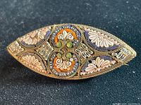 Close-up image showing detailed craftsmanship and stone arrangement on the front of the brooch.