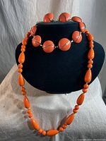 Photo of necklace with various shaped orange beads