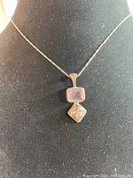 Full view of the vintage silver necklace with pendant on display bust, showing length and full pendant design.