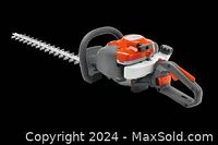 Orange gas hedge trimmer with cutter bar, side view on black background