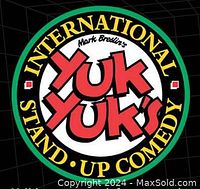 Logo of Yuk Yuk's International Stand-Up Comedy featuring red and white text on a black background with green and yellow border.