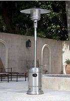 Full height view of stainless steel patio heater with reflector top and base