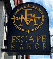 Escape Manor logo sign mounted on building facade