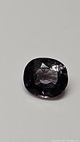 Top view of the purple spinel showing cushion cut and faceting details with clarity characteristics.