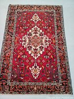 Full view of rug flat on floor showing overall design and condition