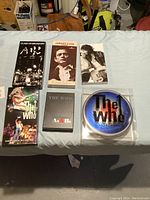 Photo of all music sets spread out on a blue sheet, including The Who, Johnny Cash, and Clash collections.