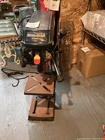 Full view of Mastercraft 10-inch bench drill press showing the base, worktable, and handles.