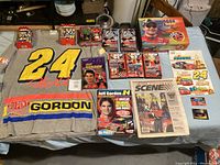 Full view of entire collection including sweatshirt, die-cast cars, books, magazines, cards.