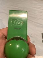 Back view of green plastic Flickers display case without ring visible.