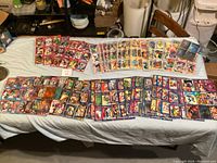 Marvel comic cards laid out on a table showing a wide assortment of different characters and series.