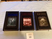 Three hardcover books by Martin Popoff about Rush lined up side-by-side showing covers of Anthem, Limelight, and Driven.