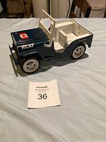 Side profile view of blue and white Tonka jeep with RCAF decal and Canadian flag sticker