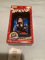 Front view of WWF Jakks Pacific Big Heads Rock collectible figure in original box, featuring a large-headed wrestler figure in packaging with red background.