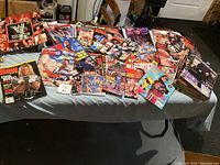 Photo showing numerous WWF Raw, WWF Integrity, WWE Collector's Guide wrestling magazines spread out on table.