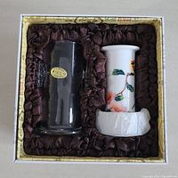 Original box containing clear glass vessel and white floral hand painted ceramic item