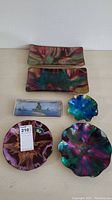 All 6 glassware pieces arranged together showing rectangular and round plates of various sizes and colors with marbled swirl glass patterns and one showing a hand-painted small rectangular piece.
