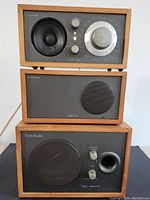 Front view of Tivoli Audio Model Two speakers and Model Subwoofer stacked vertically showing control dials and speaker grills.
