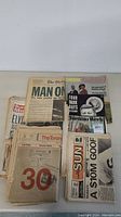Lot displaying various vintage Toronto newspapers and magazines including Toronto Telegram, Toronto Sun, Globe and Mail, and others stacked on a table.