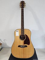 Full front view of the Oscar Schmidt acoustic guitar by Washburn showing the entire body, neck, and headstock.