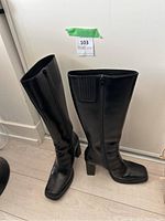 Pair of black leather boots standing upright, showing front and side profile