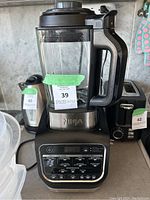 Front view of Ninja blender showing pitcher and control panel with multiple function buttons.