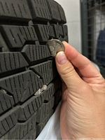 Coin test measuring tread depth on central tread block