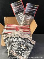 Box filled with multiple Monster's Garage and Orange County Choppers sealed decal packs