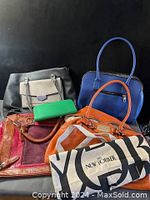 All five handbags together showing variety of colors and styles